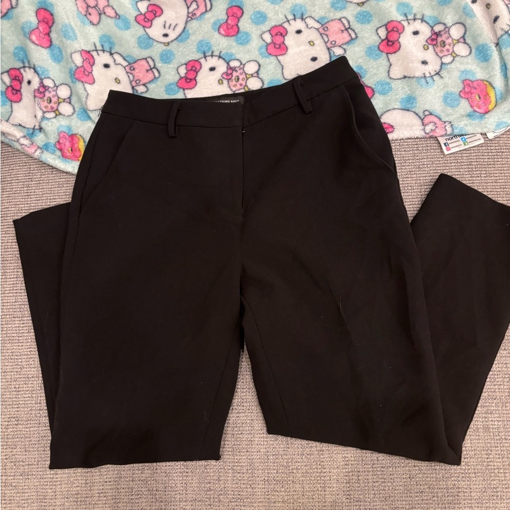 Slightly worn black straight leg women’s trousers.